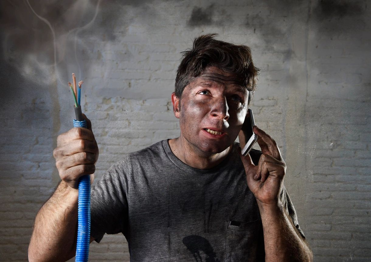 Electrical Panel Upgrade- Man Standing Holding a wire On the phone