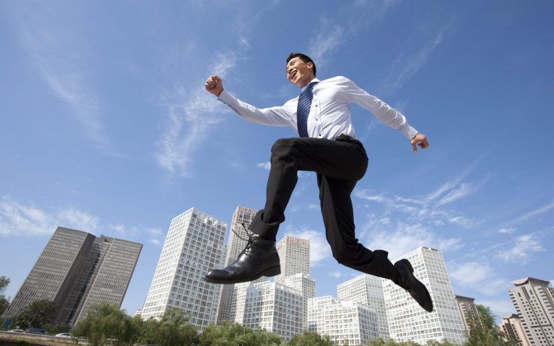 Excited Chinese businessman jumping